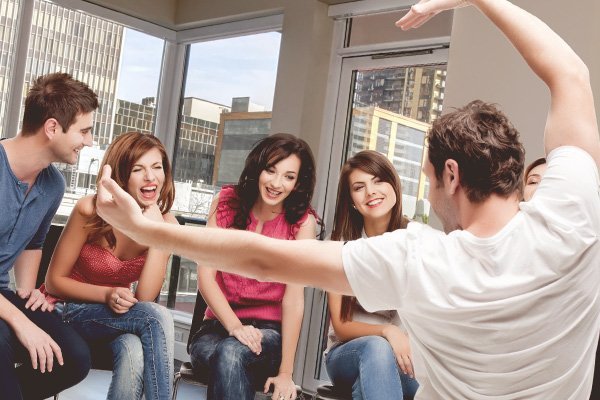 Brother and sisters playing a game of charades