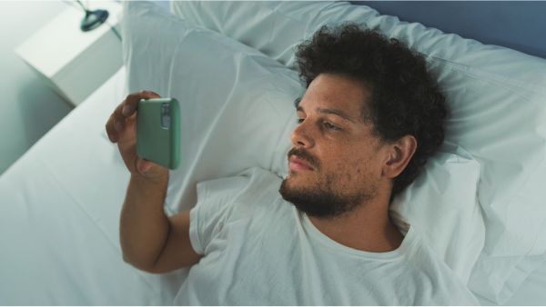 Man in bed with phone