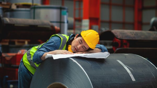 man sleeping in a factory