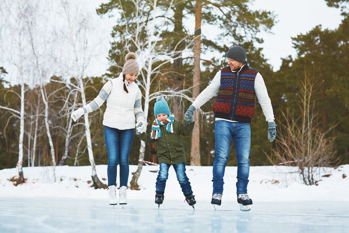 Dad teaching son to skateboard and be active outdoors