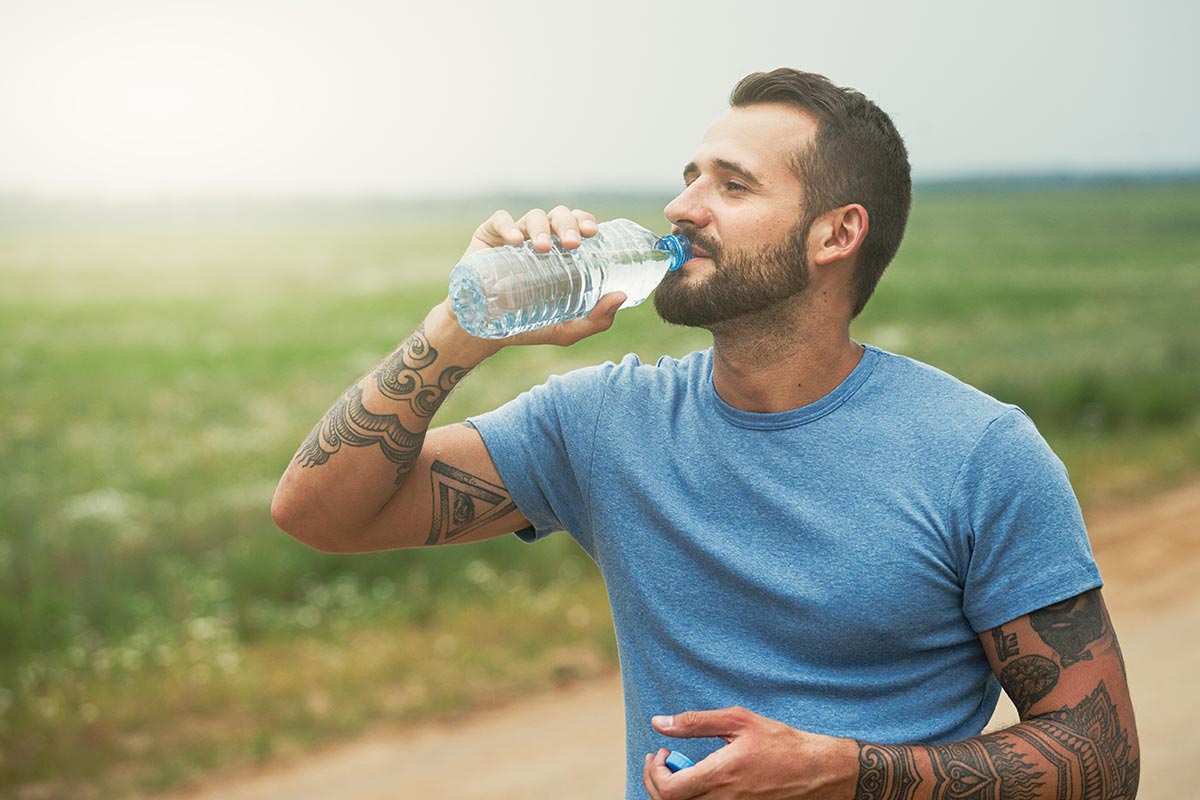 Middle-aged man drinking water.