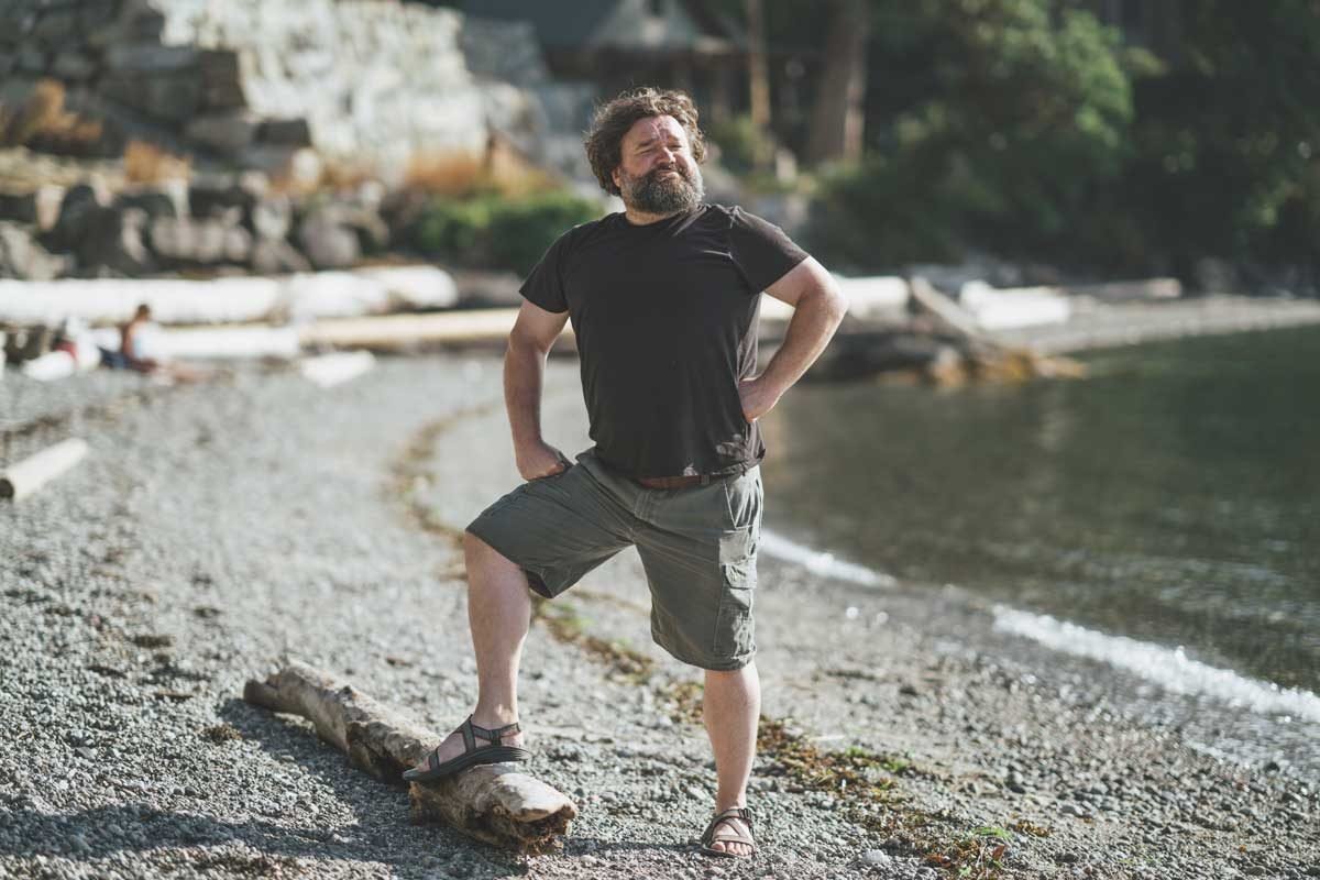 Toby hargrave by beach standing tall on a log