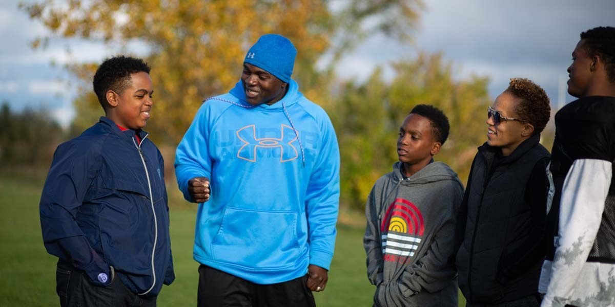 Orlando bowen coaching children on field