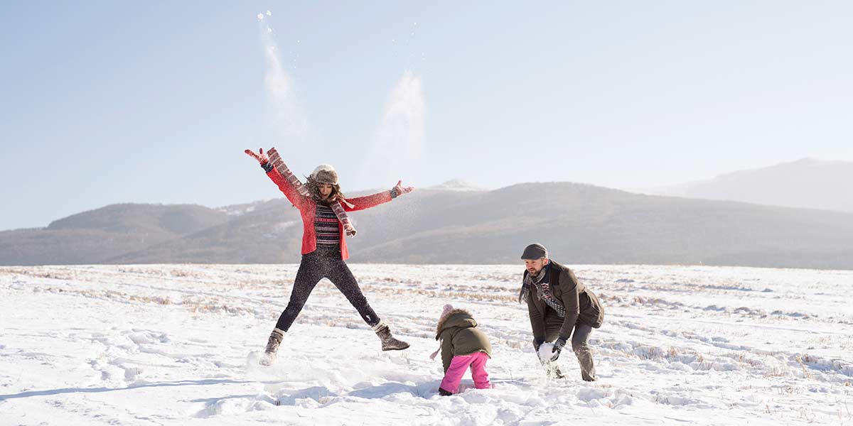 A family walking in a national park in the snow