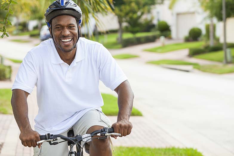 Man riding his bike and smiling