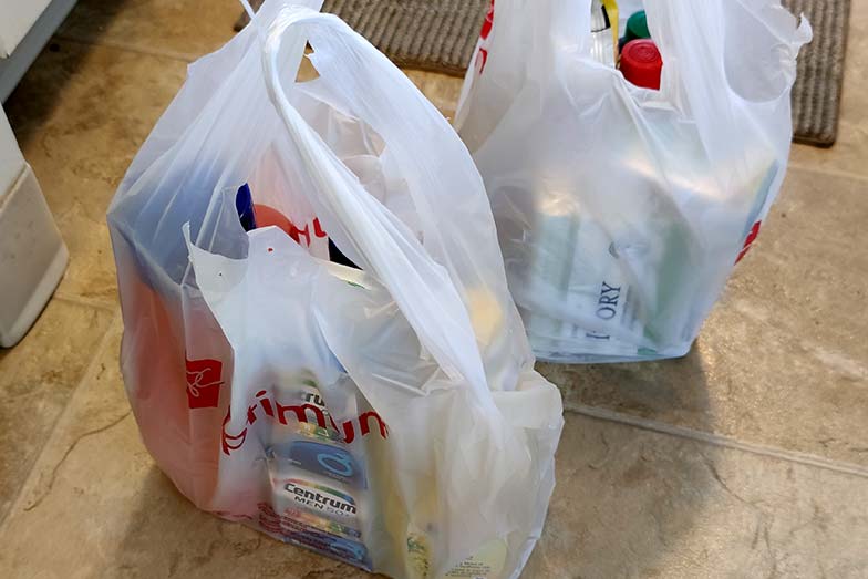 Unpacking grocery bags on the floor