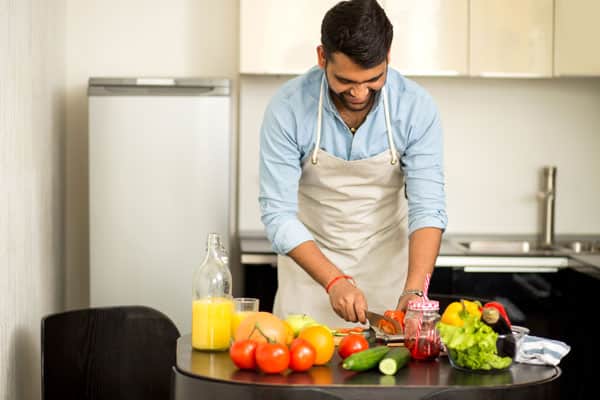 Guy chopping veg.