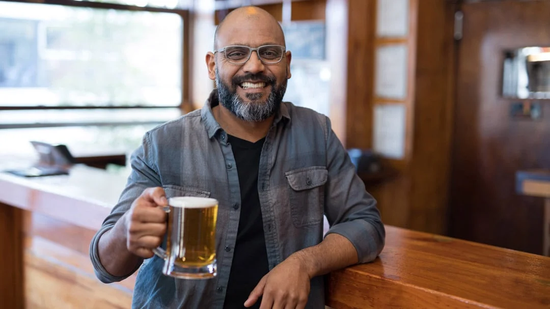 South asian man drinking beer