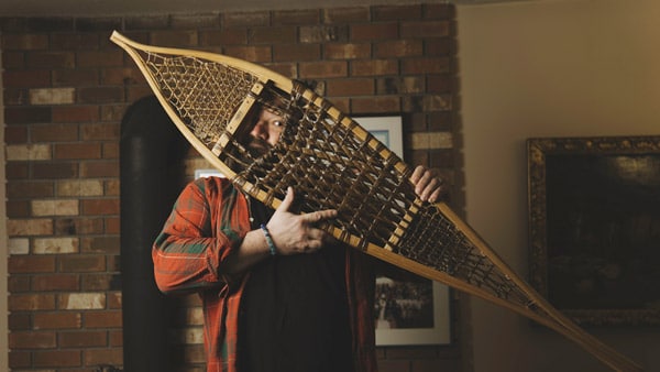 Toby hargrave holding snowshoe