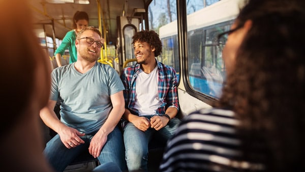 Men laughing on bus
