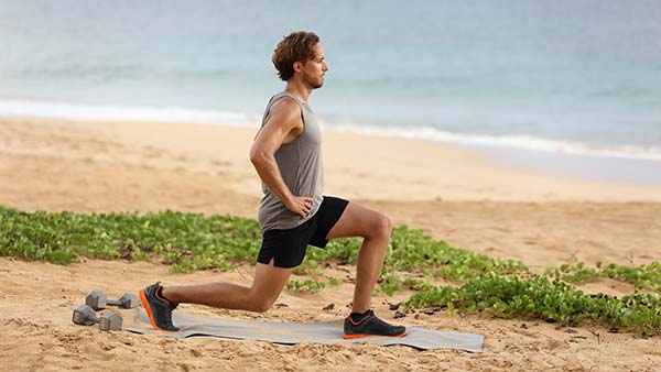 Man doing split squats