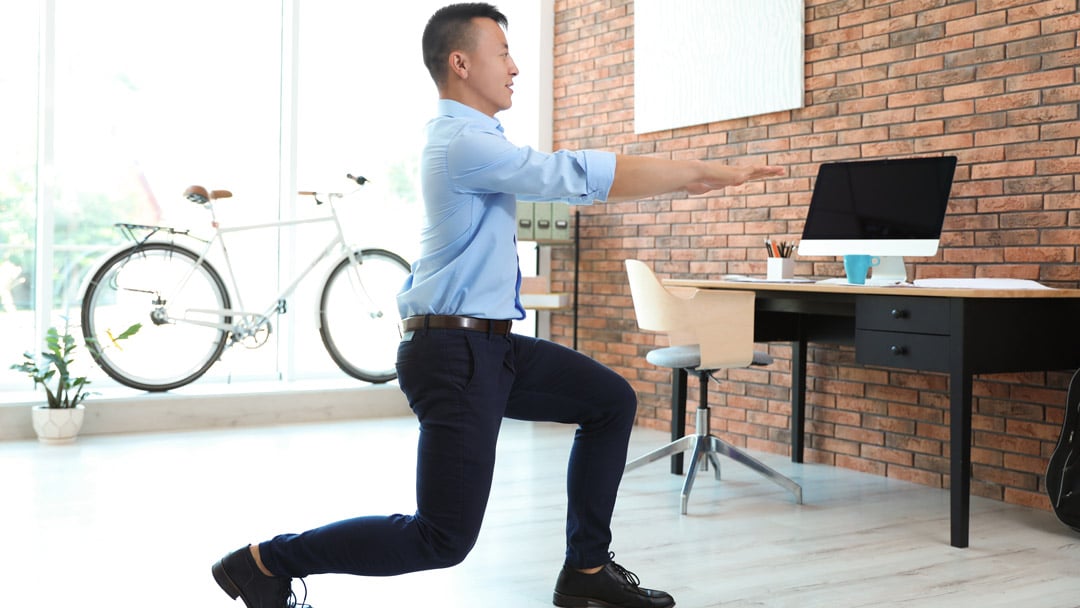 man doing lunges in office