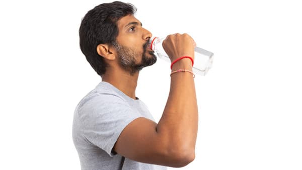 South asian man drinking water