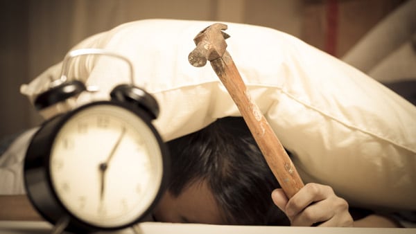 Man hitting alarm clock