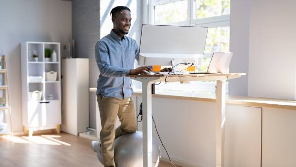 Smiling man at standing desk