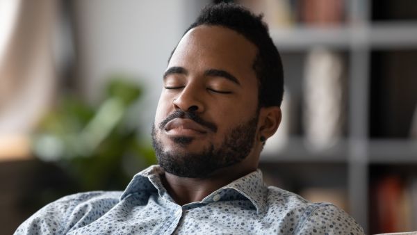 Man inhaling with eyes closed