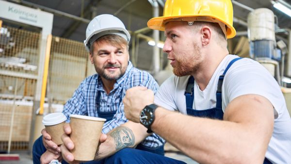 Two male workers on coffee break