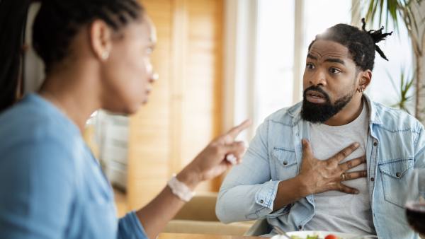 Couple arguing at table