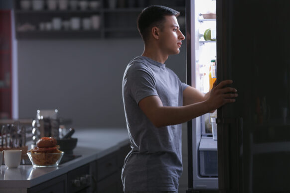 young man going to the fridge at night