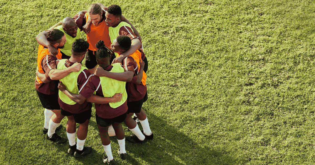 young men huddling before soccer