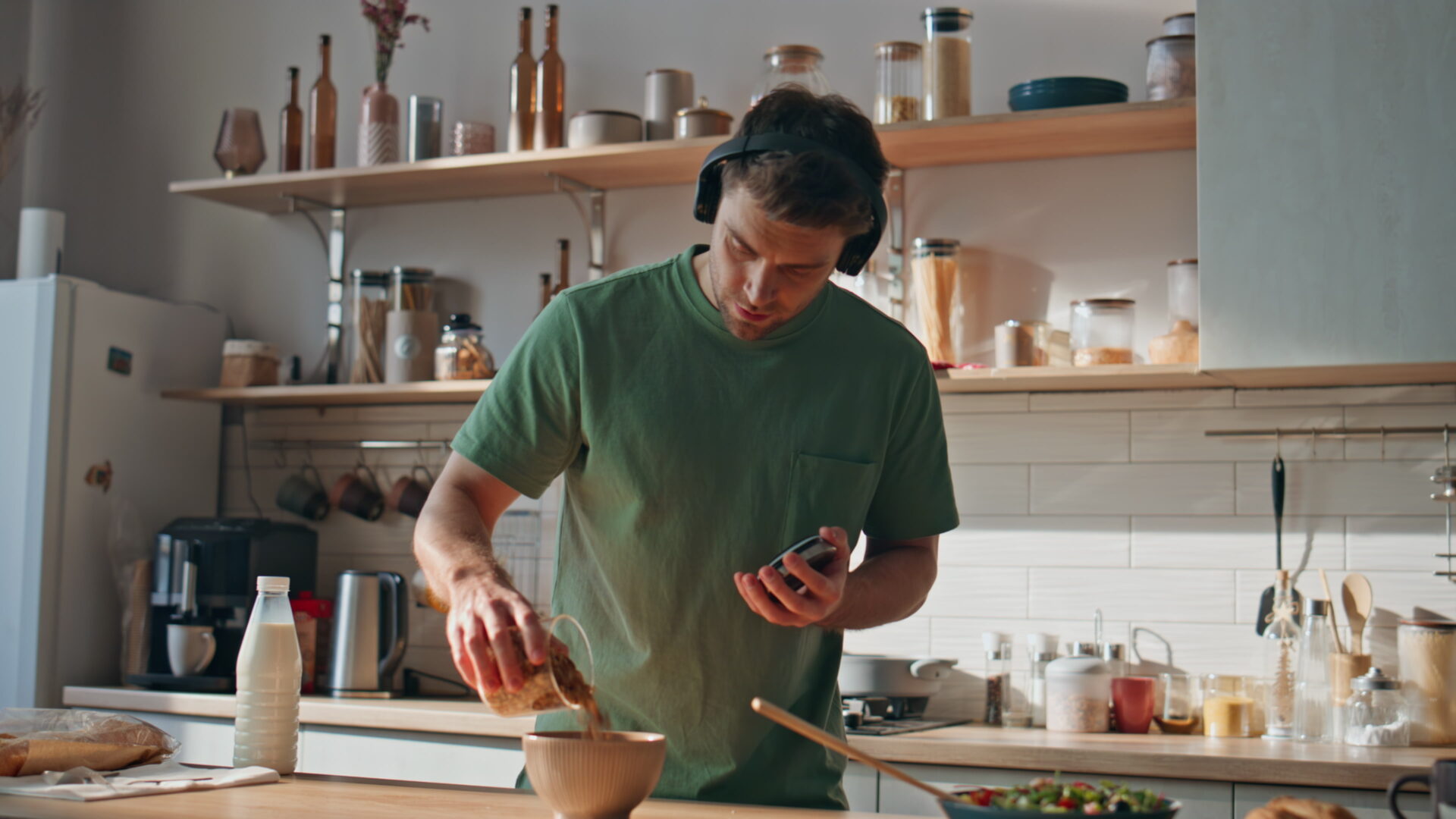 Man listening music cooking in headphones