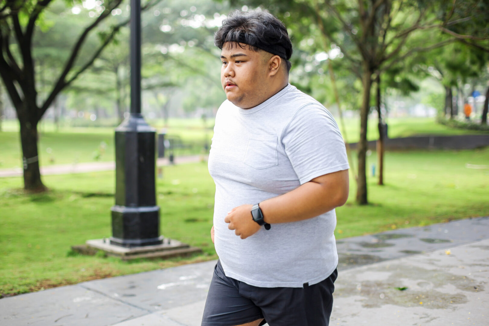 Young Asian Man Jogging In Park