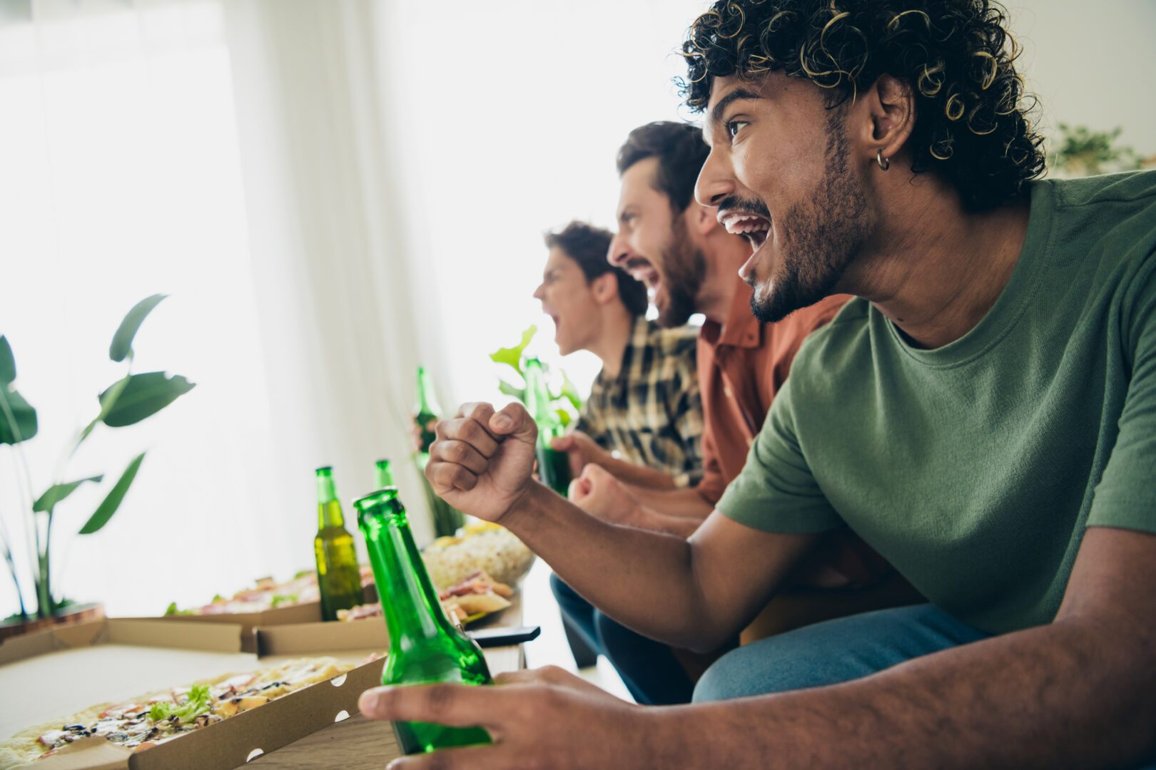 men drinking beer cheering sports