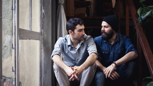 two guys talking on stairs